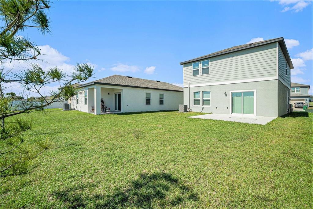 35542 Buttonweed Trail Zephyrhills, FL 33541 - Photo 27 of 30 a house view with a garden space