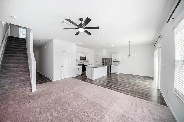 a view of empty room with wooden floor and window
