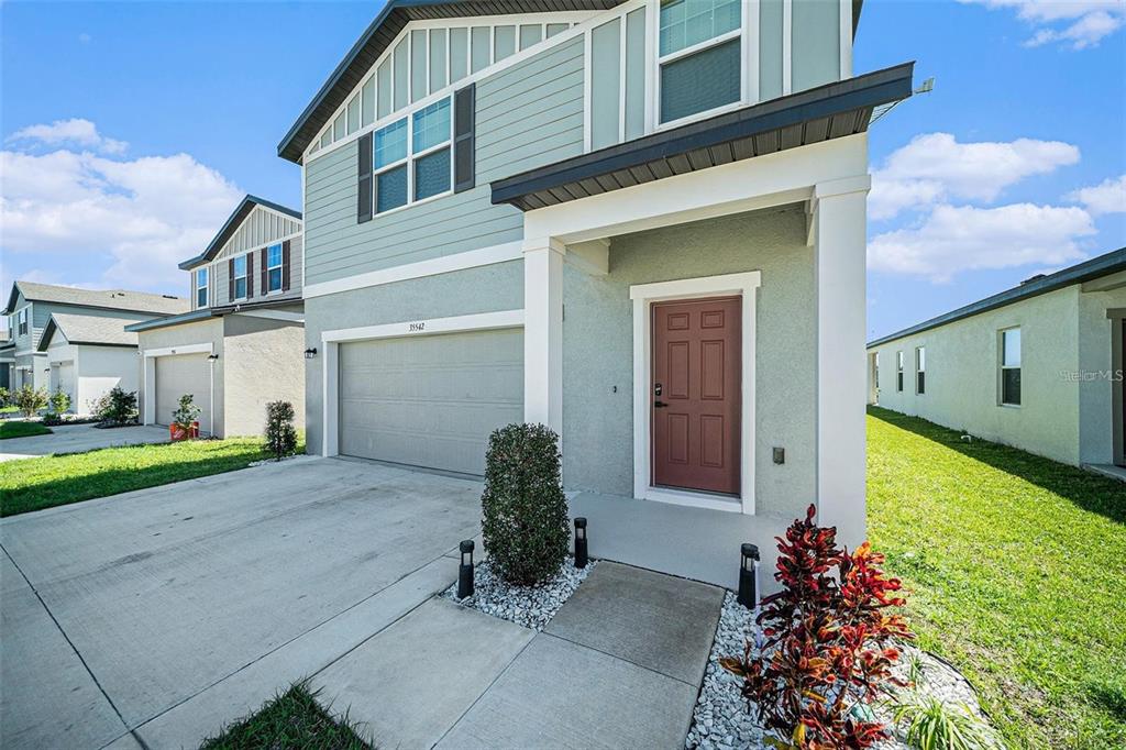 35542 Buttonweed Trail Zephyrhills, FL 33541 - Photo 6 of 30 a front view of a house with garden