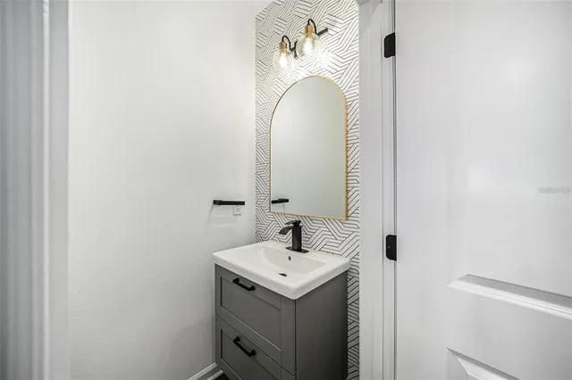 a bathroom with a sink and mirror
