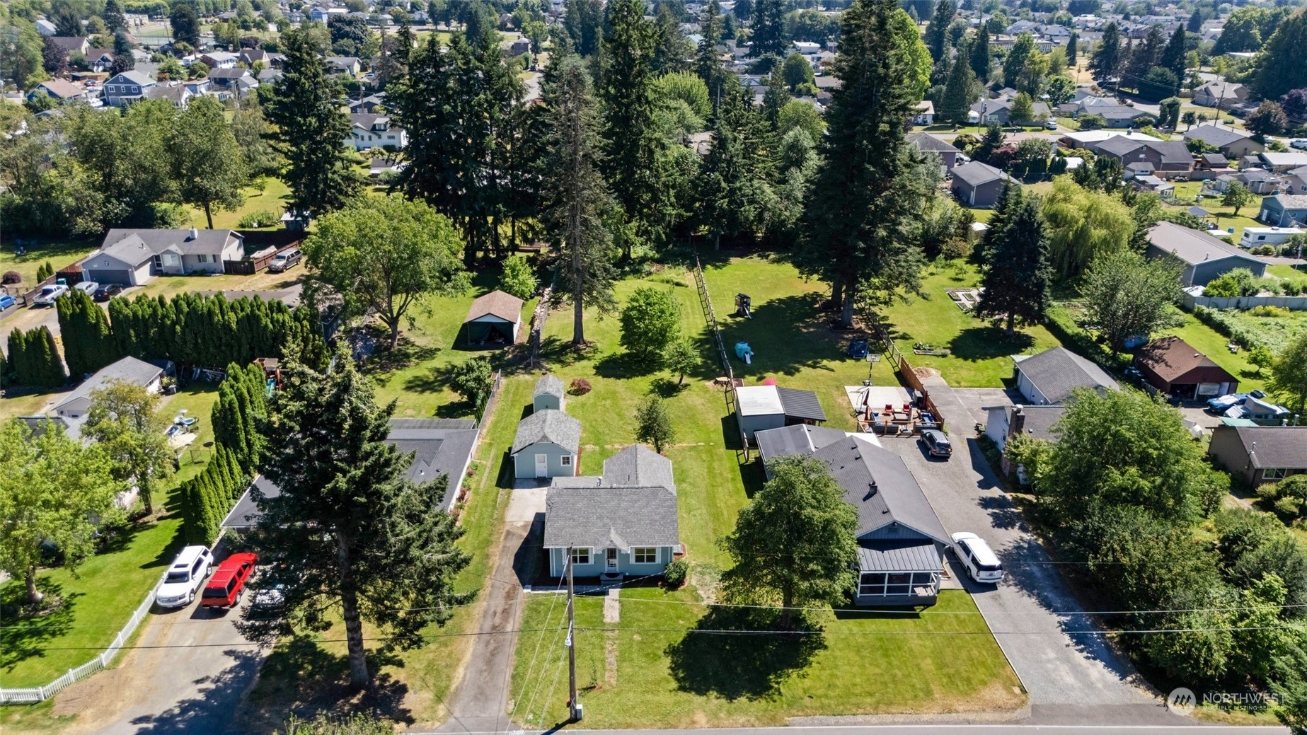 1918 McHugh Avenue Enumclaw, WA 98022 - Photo 2 of 16 an aerial view of residential houses with yard and swimming pool