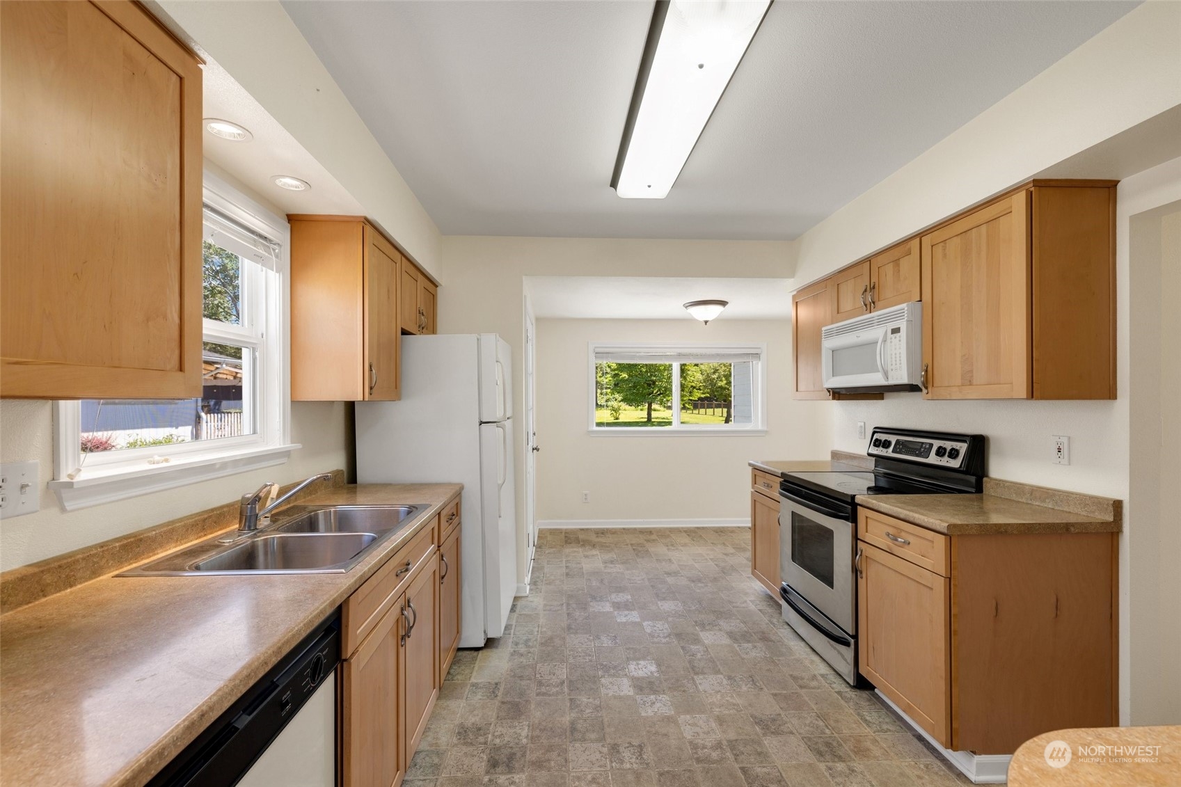 1918 McHugh Avenue Enumclaw, WA 98022 - Photo 5 of 16 a kitchen that has a sink a stove and cabinets