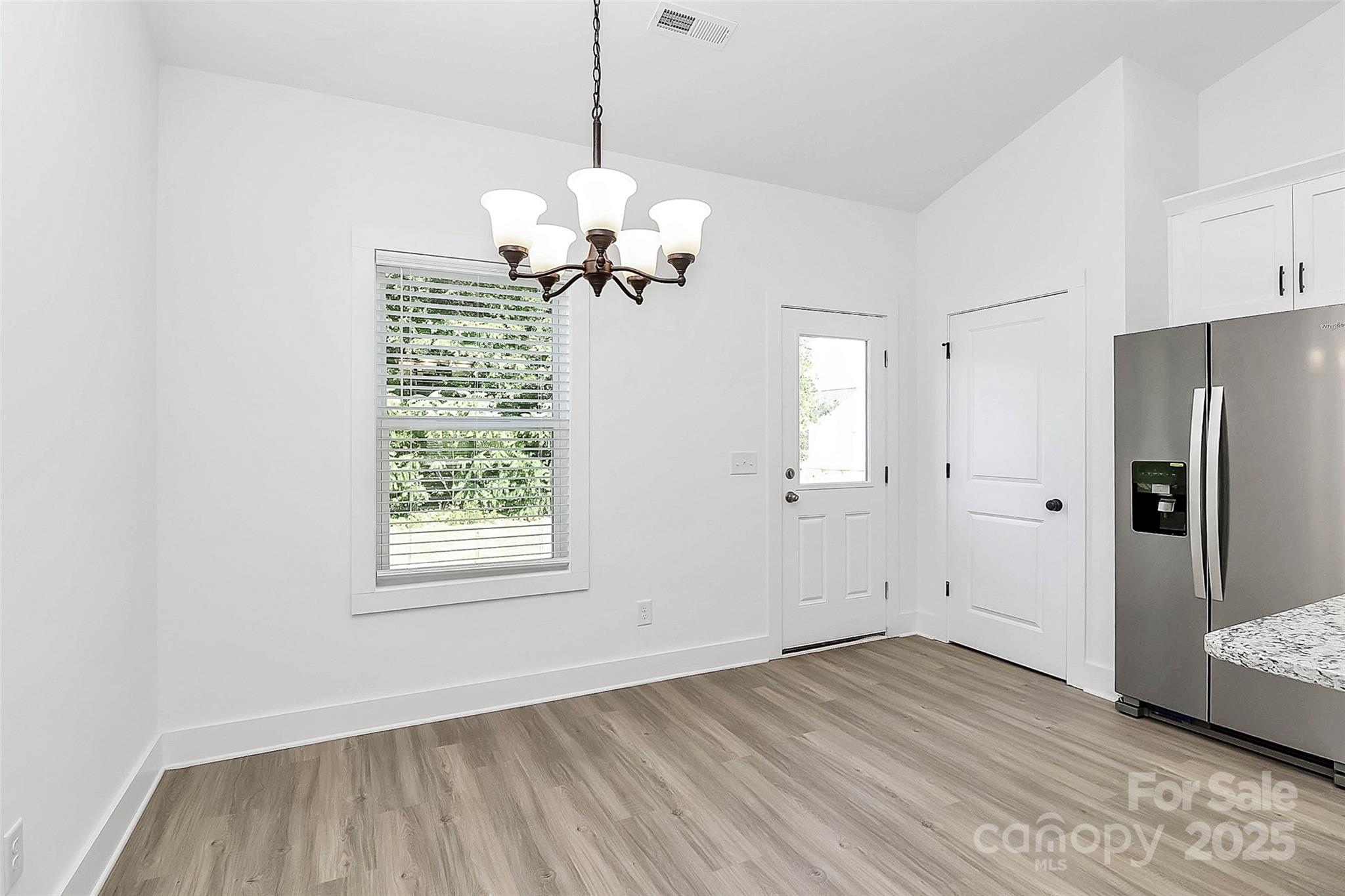 6122 Lowder Road Salisbury, NC 28147 - Photo 13 of 31 a view of an empty room with a window and wooden floor