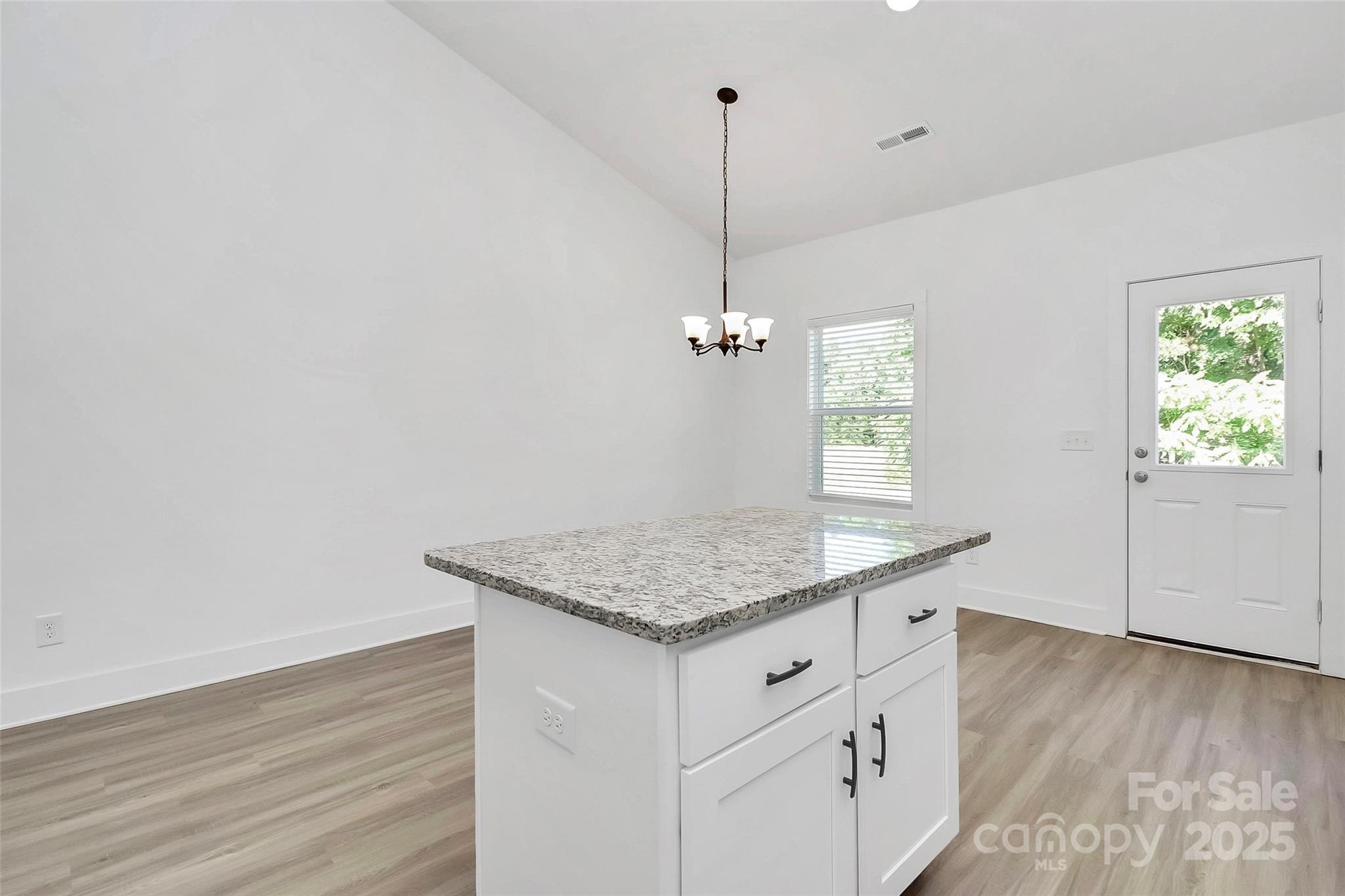 6122 Lowder Road Salisbury, NC 28147 - Photo 14 of 31 a kitchen with a granite countertop sink cabinets and wooden floor