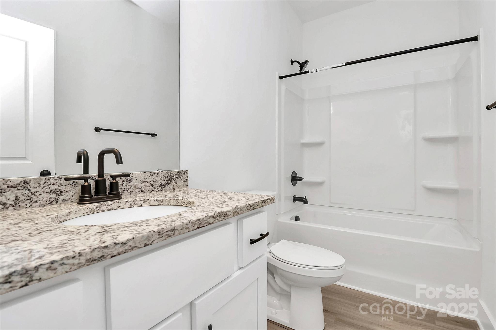 6122 Lowder Road Salisbury, NC 28147 - Photo 18 of 31 a bathroom with a granite countertop sink toilet and shower