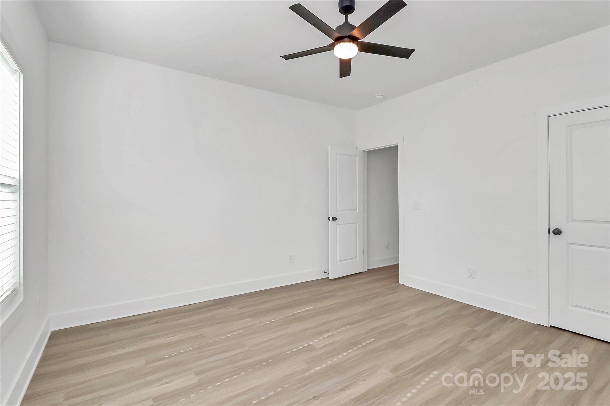 6122 Lowder Road Salisbury, NC 28147 - Photo 21 of 31 an empty room with wooden floor and windows