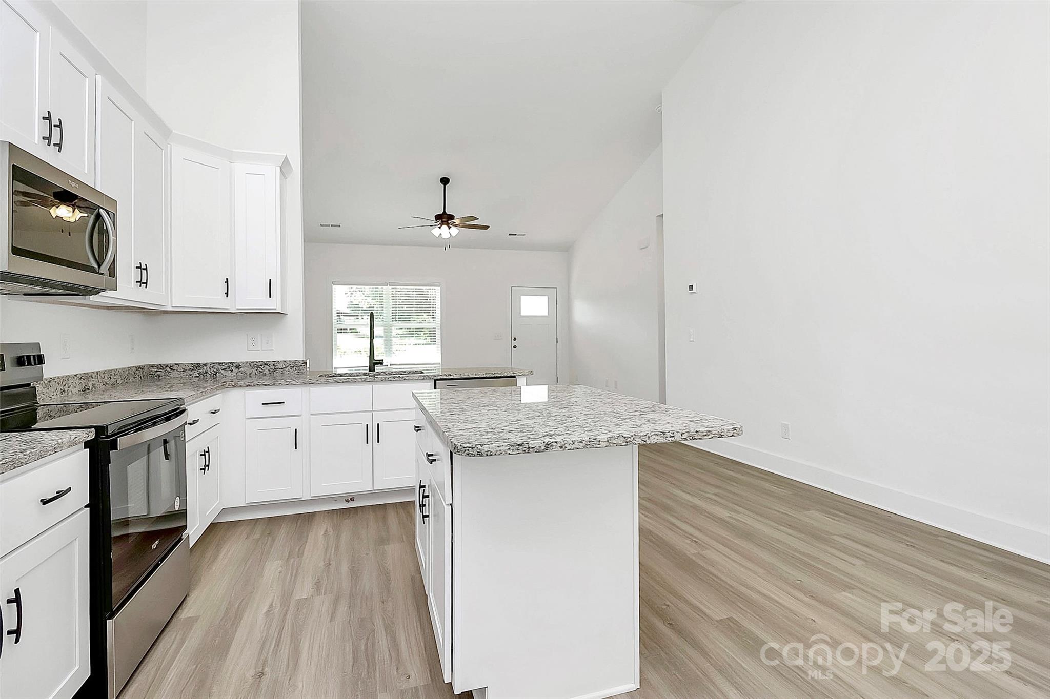 6122 Lowder Road Salisbury, NC 28147 - Photo 7 of 31 a kitchen with granite countertop white cabinets and white appliances