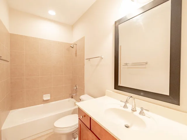 a bathroom with a sink mirror toilet and bathtub