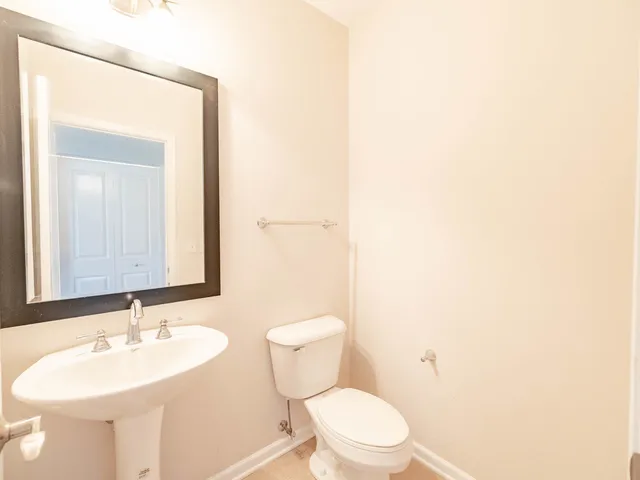 a bathroom with a toilet a sink and a mirror