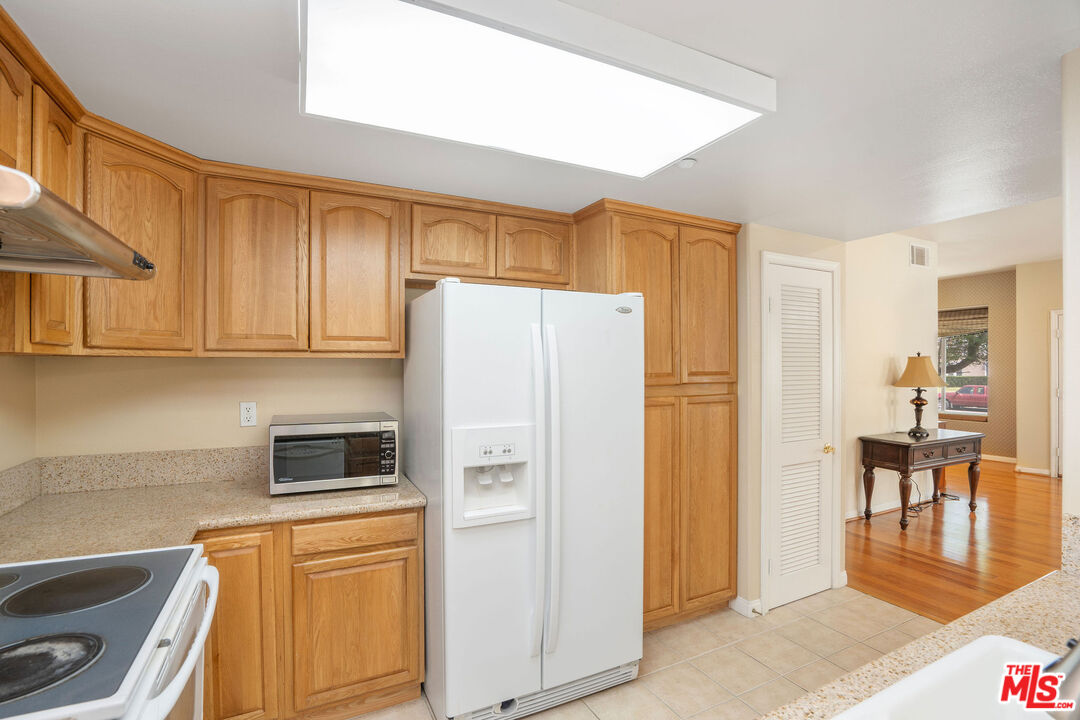 1128 West Duarte Road, Unit A Arcadia, CA 91007 - Photo 14 of 28 a kitchen with stainless steel appliances a refrigerator and a stove top oven
