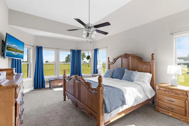 a bedroom with a large bed and a large window