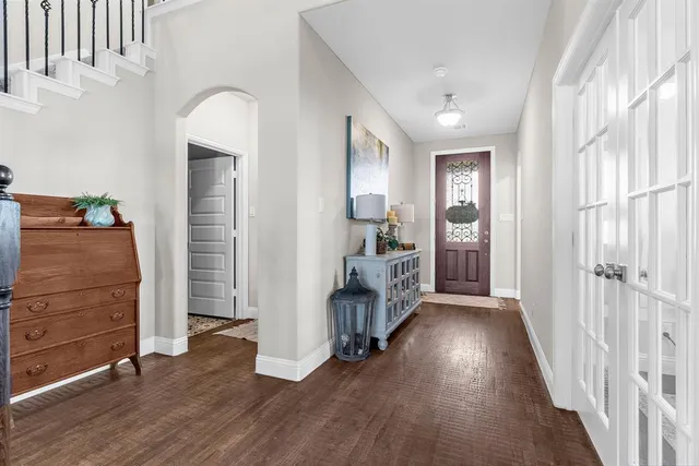 a view of a hallway with closet and wooden floor