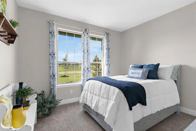 a bed sitting in a bedroom next to a window