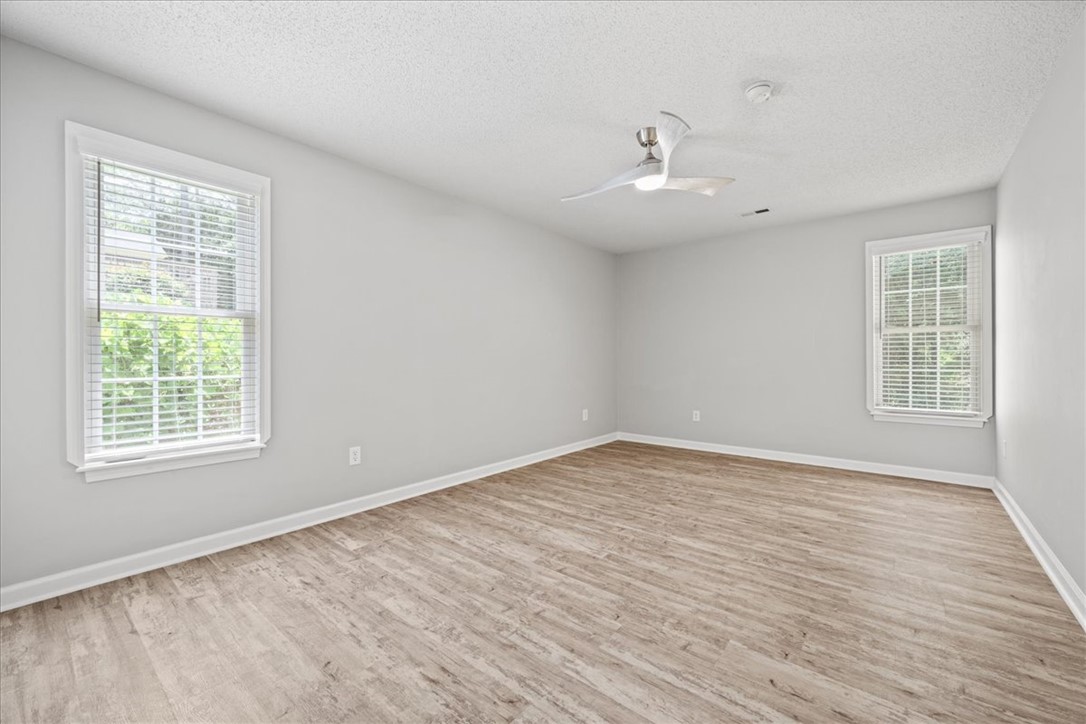 212 Blue Ridge Drive Clemson, SC 29631 - Photo 14 of 33 A well-lit bedroom features durable laminate flooring and a modern ceiling fan.