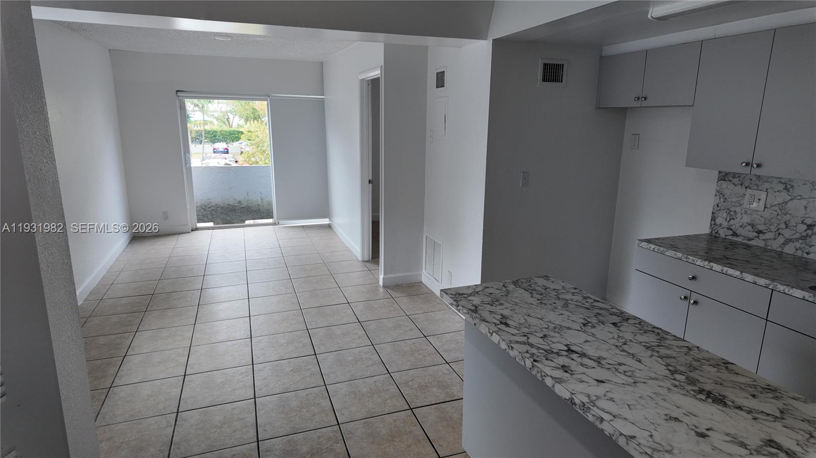 11120 Southwest 196th Street, Unit 201 Cutler Bay, FL 33157 - Photo 1 of 18 a kitchen with granite countertop a stove a refrigerator and cabinets