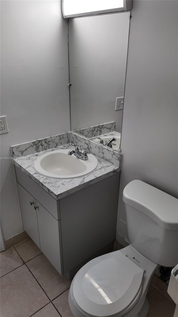 11120 Southwest 196th Street, Unit 201 Cutler Bay, FL 33157 - Photo 14 of 18 a bathroom with a toilet sink and mirror