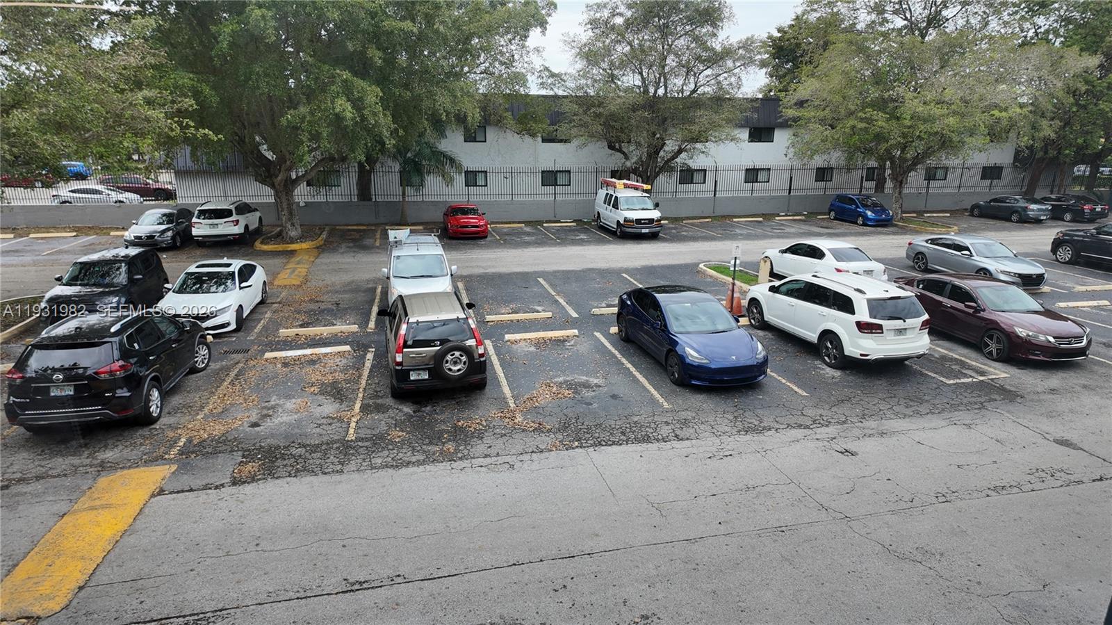 11120 Southwest 196th Street, Unit 201 Cutler Bay, FL 33157 - Photo 18 of 18 a couple of cars parked in front of a house