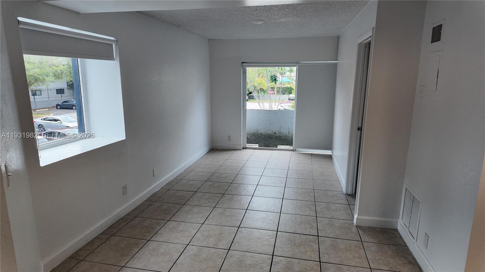 11120 Southwest 196th Street, Unit 201 Cutler Bay, FL 33157 - Photo 2 of 18 a view of an empty room with window and bathroom