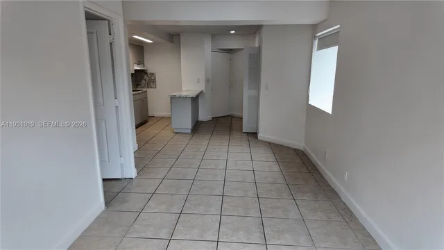 a view of an empty room with a bathroom