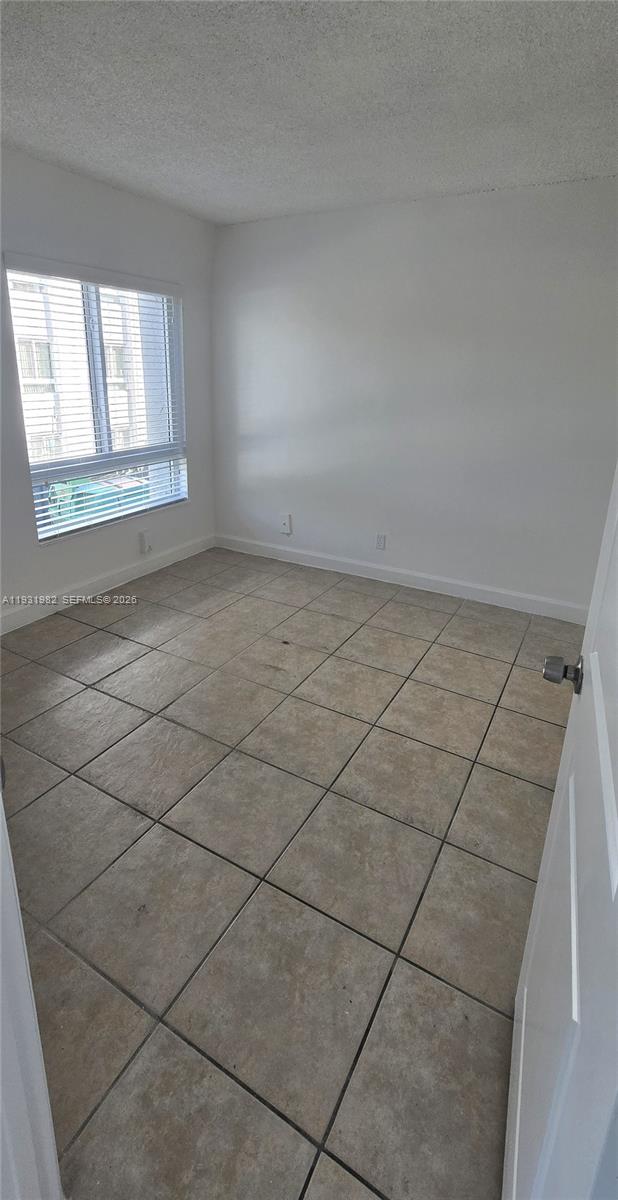 11120 Southwest 196th Street, Unit 201 Cutler Bay, FL 33157 - Photo 8 of 18 a view of a livingroom with an empty space and a window