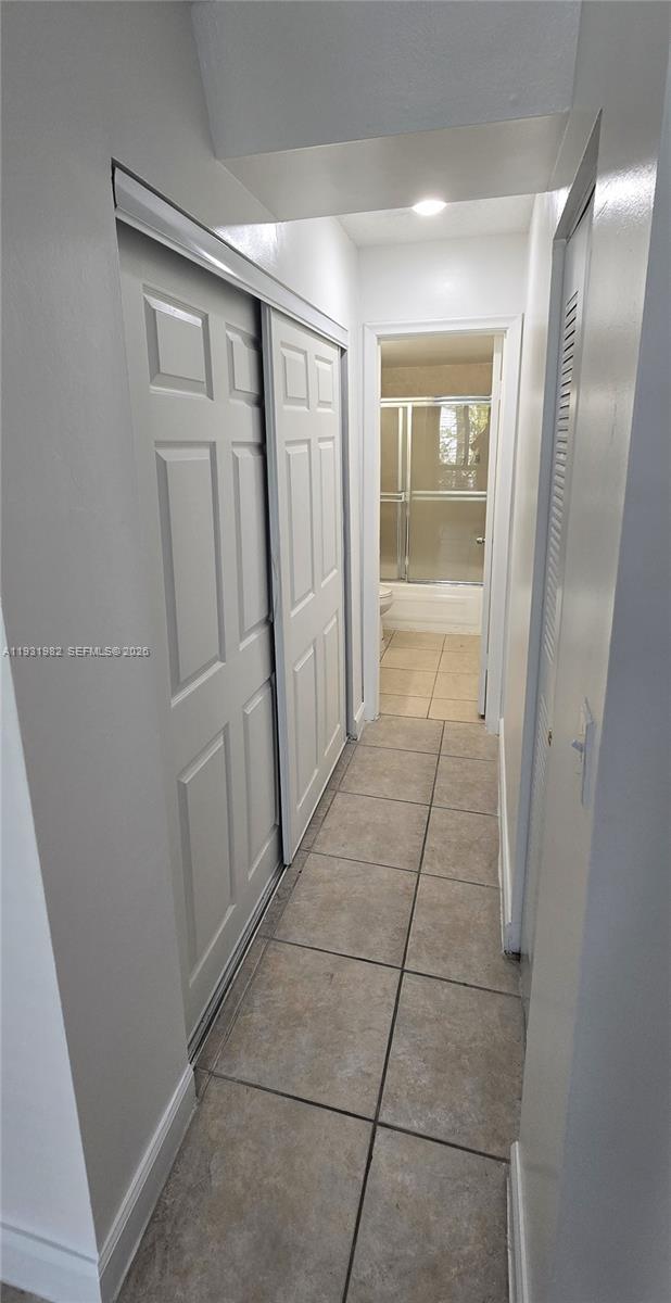 11120 Southwest 196th Street, Unit 201 Cutler Bay, FL 33157 - Photo 9 of 18 a bathroom with a glass door shower