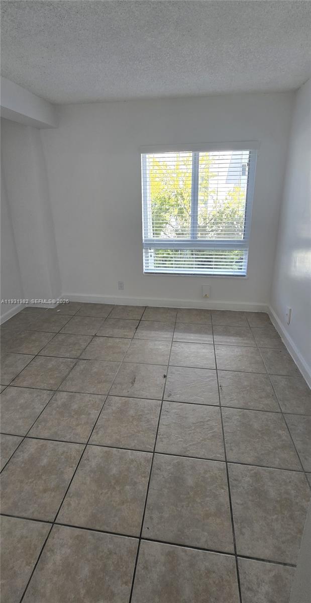 11120 Southwest 196th Street, Unit 201 Cutler Bay, FL 33157 - Photo 10 of 18 a view of an empty room with a window