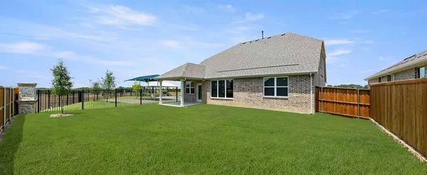 a view of a house with backyard porch and garden