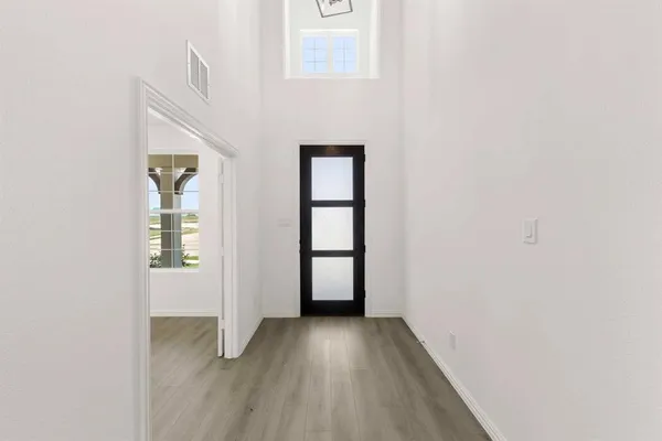 an empty room with windows and closet