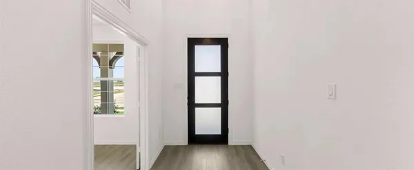 a view of an entryway with wooden floor