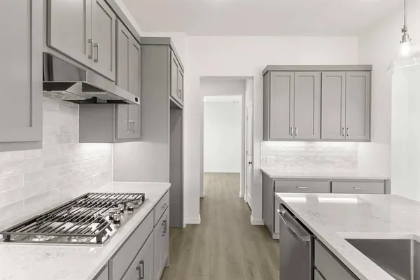 a kitchen with a stove and a sink