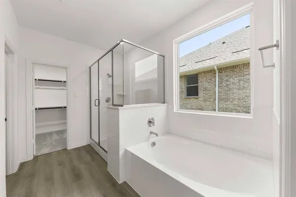 a bathroom with a bathtub and a shower