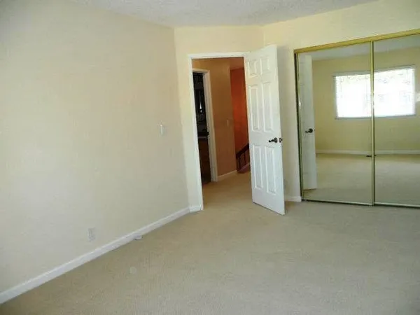 an empty room with windows and closet
