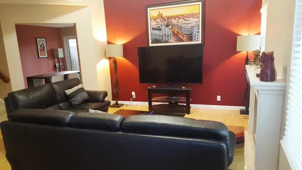 a living room with furniture and a flat screen tv