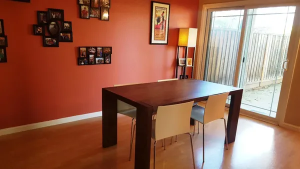 a view of a dining room with furniture and wooden floor