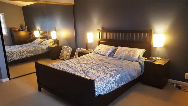 a bedroom with bed and window