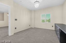 7701 West Robindale Road, Unit 277 Las Vegas, NV 89113 - Photo 11 of 33 A well-lit room offers plush carpeting and a modern light fixture.