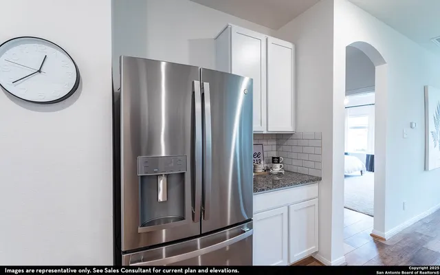 a kitchen with a refrigerator and cabinets