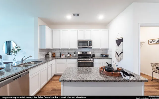 a kitchen with stainless steel appliances granite countertop a sink stove and cabinets