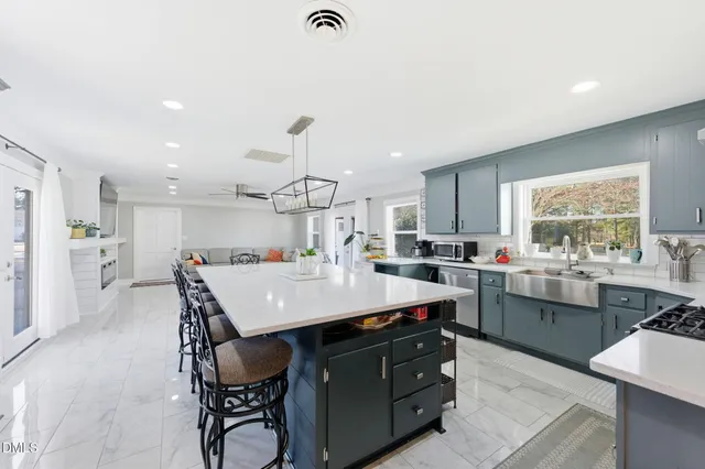 a large kitchen with a table and chairs in it