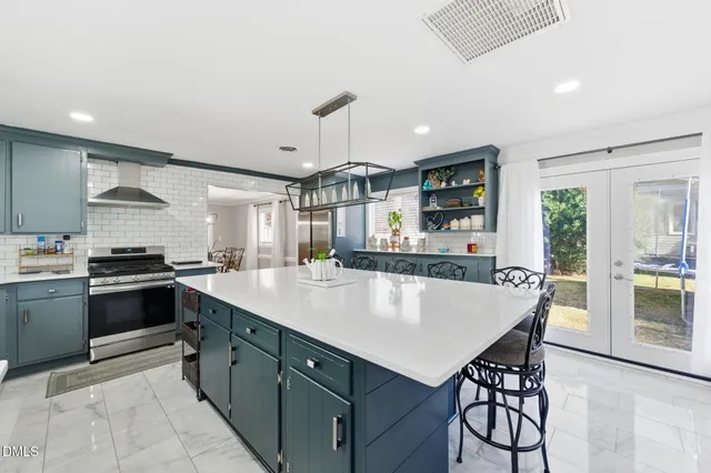 a living room with furniture and a ceiling fan