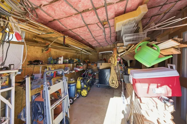 a view of a wooden house with a patio and a yard