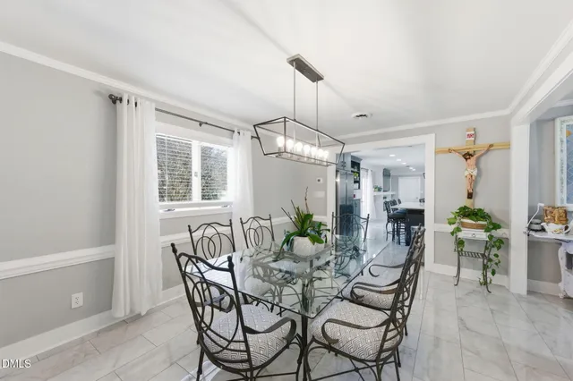 a view of a dining room with furniture and chandelier