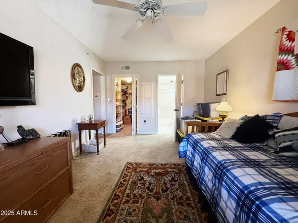 a bed room with furniture and a flat screen tv