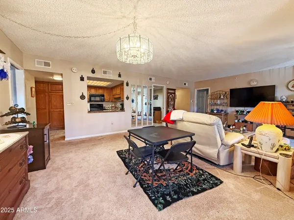 a living room with furniture rug and a chandelier