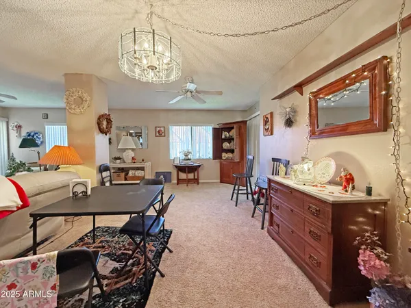 a view of a dining room with furniture and chandelier