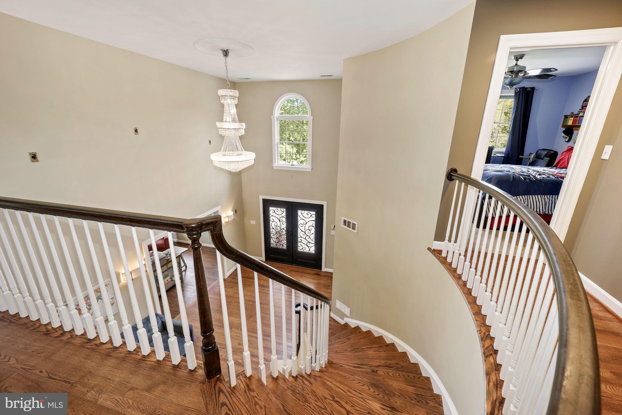 8100 Pinehurst Harbour Way Pasadena, MD 21122 - Photo 48 of 70 Curved staircase from center hall to main level