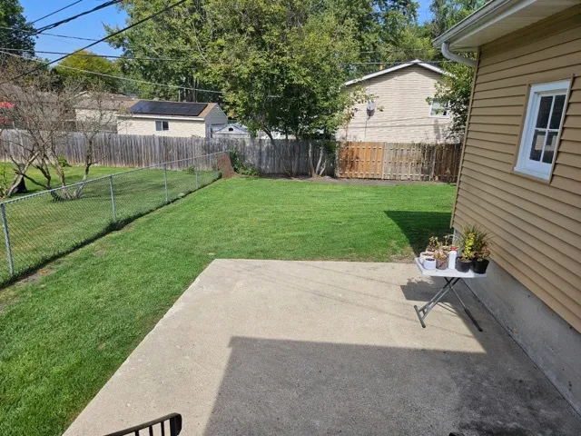 a view of a backyard with sitting area