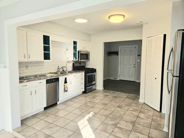 a kitchen with a stove a sink and a refrigerator