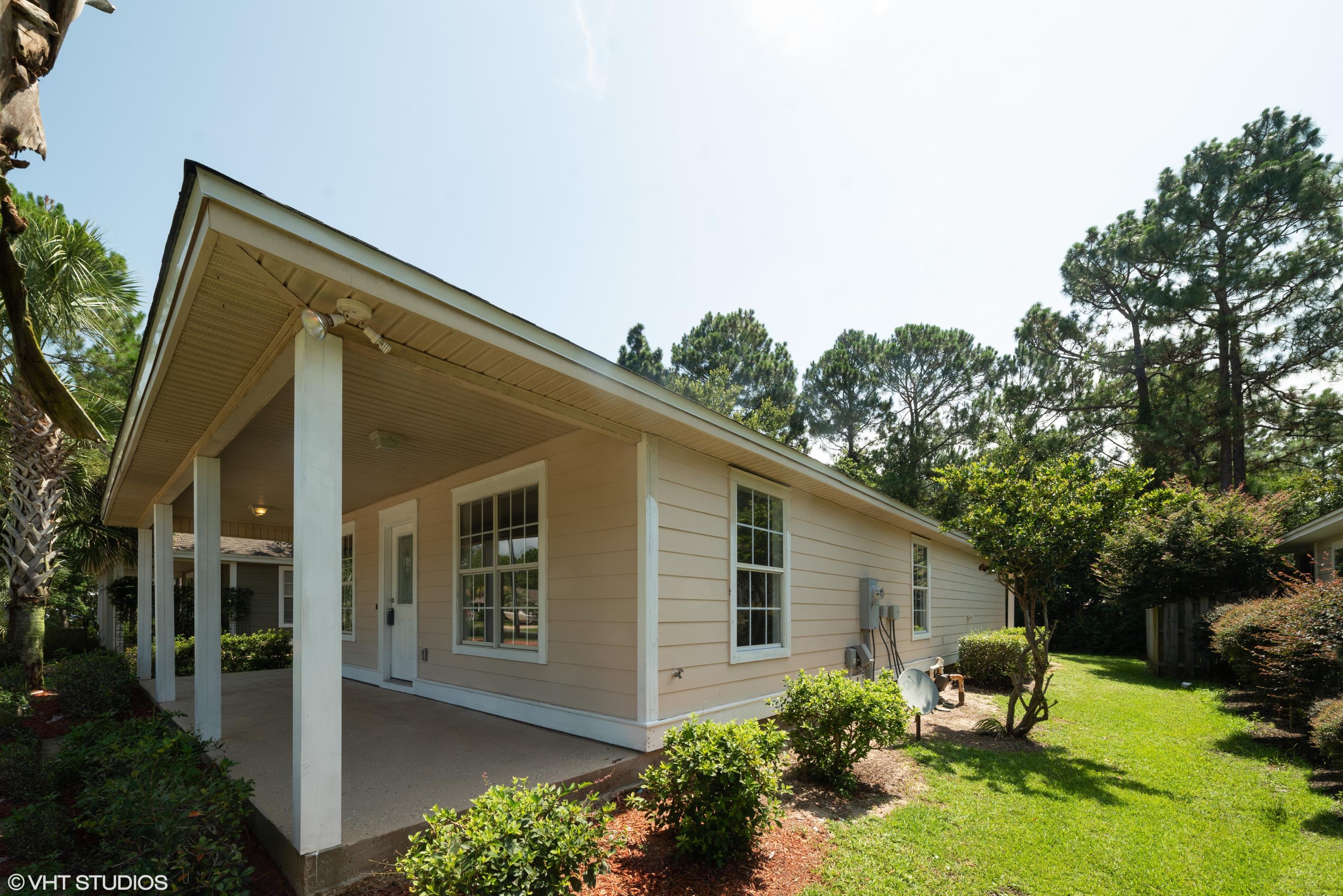 92 Central 7th Street Santa Rosa Beach, FL 32459 - Photo 2 of 25 a backyard of a house with yard and outdoor seating