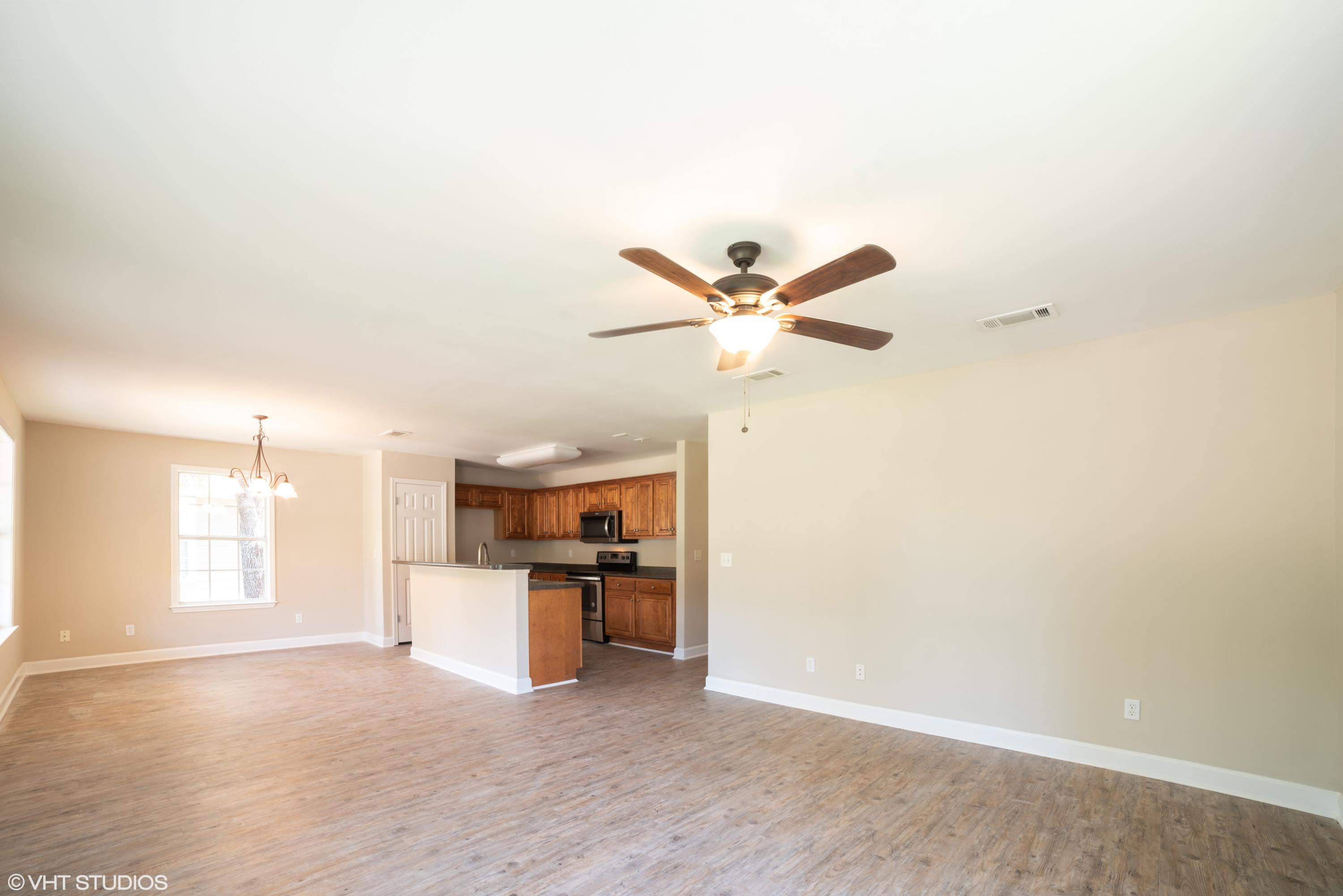 92 Central 7th Street Santa Rosa Beach, FL 32459 - Photo 12 of 25 a view of a kitchen with a sink wooden floor and a window